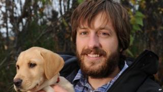 Justin Priest, pictured with his puppy (9 October 2014)