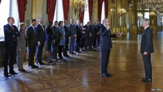 The chief of Belgium"s Francophone Liberal Party (MR) Charles Michel (L) is sworn in as Prime Minister in the presence of King Philippe (R) at the Brussels Royal Palace in Brussels October 11, 2014.