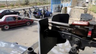 Iraqi policemen search a car at a checkpoint in Baghdad, Iraq, on 11 October 2014.