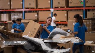 Китайские рабочие упаковывают товары на складе в Шанхайской зоне свободной торговли