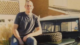 Steven Adderson sitting on his Land Rover