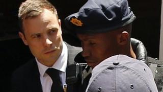 South African Olympic and Paralympic sprinter Oscar Pistorius being escorted to a police van after his sentencing at the North Gauteng High Court in Pretoria - 21 October 2014