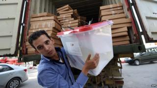 A Tunisian employee of the Independent High Authority for the Elections (ISIE) unloads ballot boxes ahead of the counting process in the Tunis suburb of Ariana on October 27, 2014.AFP PHOTO / FETHI BELAIDFETHI BELAID/AFP/Getty Images