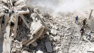 Residents look for survivors under the rubble of collapsed buildings after what activists said was a vacuum bomb dropped by forces of Syria"s President Bashar al-Assad on Maarat Al-Nouman, south of Idlib September 18, 2014