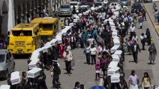 A procession of coffins with the exhumed bodies of 80 victims of Peru's internal conflict, October 27,2014