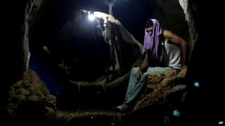 A Palestinian worker rests inside a tunnel between Egypt and Gaza