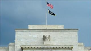 The US flag flaps over the Federal Reserve building in Washington