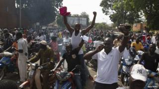 People celebrate the departure of Burkina Faso"s President Blaise Compaore in Ouagadougou, capital of Burkina Faso