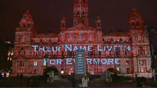 The projections on the side of the City Chambers read: Their Name Liveth for Evermore