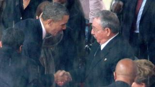 President Barack Obama shakes Raul Castro's hand at Nelson Mandela's funeral in South Africa.
