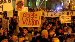 People protest in front of the Hungarian parliament in Budapest, Hungary on 17 November 2014