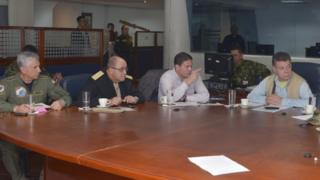 Colombian President Juan Manuel Santos (R) attends a meeting accompanied by Defence Minister Juan Carlos Pinzon and head military commanders in Choco, November 16, 2014