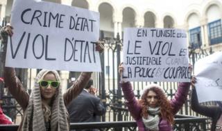 Tunisian women demonstrate outside a courthouse where three police officers face charges of raping of a 27-year-old woman, in Tunis, Tunisia, in March 2014