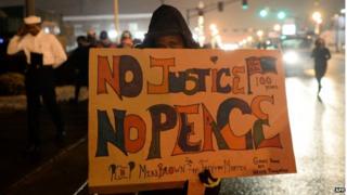 Demonstrators march along a street in Ferguson, Missouri, on November 26, 2014