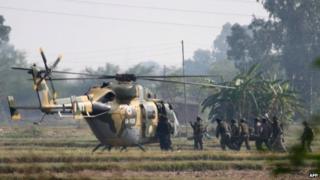 An Indian Army soldier allegedly injured during an encounter with militants is evacuated by helicopter in the village of Pindi near the Line of Control between India and Pakistan