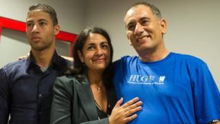 Felix Baez, right, with wife Vania Ferrer and his son Alejandro at the Jose Marti International Airport in Havana. 6 Dec 2014