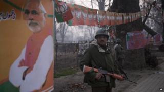 Paramilitary soldiers stand outside Sheri Kashmir cricket stadium where PM Modi is expected to speak on Monday