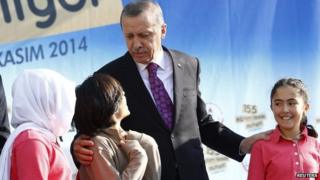Turkey's President Tayyip Erdogan talks with during a school opening ceremony in Ankara