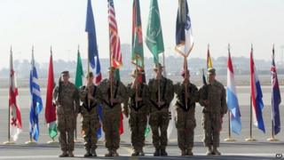 International Security Assistance Forces take party in a ceremony in Kabul, Afghanistan, Monday, Dec. 8, 2014.