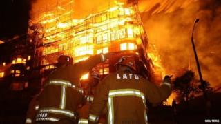 Los Angeles city firefighters battle a massive fire at a seven-storey downtown apartment complex under construction in Los Angeles, California 8 December 2014
