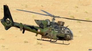 A French army helicopter Gazelle flies over the desert during the Hydra Operation on 29 October 2013 near the village of Bamba between Timbuktu and Gao, northern Mali