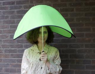 Woman under futuristic green umbrella