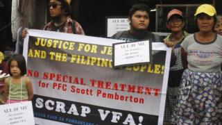 Supporters of slain transgender Filipino Jennifer Laude, whose former name was Jeffrey, hold placards during a rally outside a courthouse in Olongapo city, north of Manila December 15, 2014