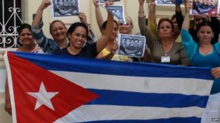 Cubans celebrate release of prisoners with national flag in Camaguey, east of Havana. 17 Dec 2014