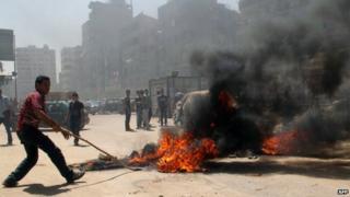 Supporters of the ousted Islamist president block a road with burning tires in Cairo's northern district of Matariya on August 14, 2014