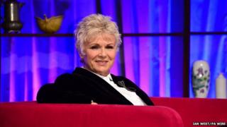 Julie Walters sitting on sofa on stage at Bafta