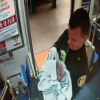 Police sergeant holds baby born on train in Philadelphia (25 Dec)