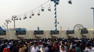Pakistani Muslims gather at a fairground as they celebrate Eid al-Fitr in Karachi on 30 July 30, 2014