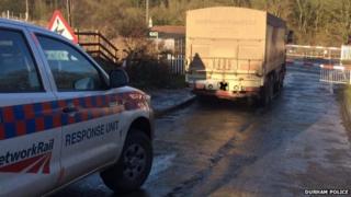 The lorry against the barrier