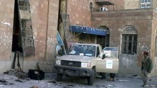 A soldier is seen outside a cultural centre following a suicide attack in Ibb, Yemen, 31 December 2014