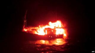 This handout photograph released by The Indian Ministry of Defence on January 2, 2015, is said to show a burning vessel off the coast of the western Indian state of Gujarat in the Arabian Sea early on January 1, 2015.
