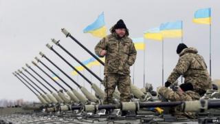 Ukrainian servicemen on an armoured personal carrier at a military base near Zhytomir, about 140km west of the capital Kiev (05 January 2015)