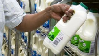 Man taking milk off shelf