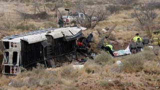 Officials investigate the scene of a prison transport bus crash in Penwell, Texas 14 January 2015