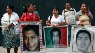 Relatives of the 43 missing students protest outside the Attorney General's office in Mexico City