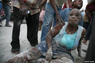 A woman covered in dust after the earthquake