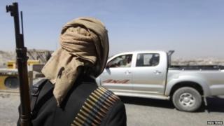 A Houthi fighter mans a checkpoint on a road leading to the US embassy in Sanaa (21 January 2015)