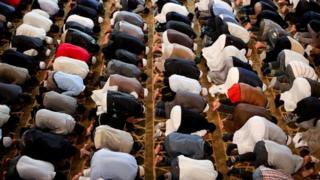 Men praying in a London mosque