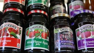 Smuckers fruit products are displayed on a shelf at a grocery store in California.