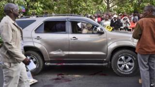Onlookers gather at the scene after a Kenyan lawmaker was shot dead by gunmen on a main street in Nairobi, Kenya