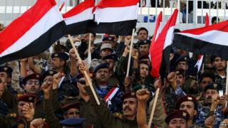 Yemeni army officers loyal to the Shiite Houthi Group shout slogans and wave Yemeni flags during a celebration on a new constitutional declaration announced one day ago by the Group in Sana'a, Yemen, 07 February 2015