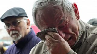 A man reacts emotional as residents pay respect to the victims of a shooting at a restaurant in the city of Uhersky Brod, Czech Republic, 25 February 2015.