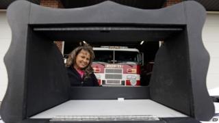 Monica Kelsey, a fire-fighter and medic who is president of Safe Haven Baby Boxes Inc., poses with a prototype of a baby box in Woodburn, Indiana