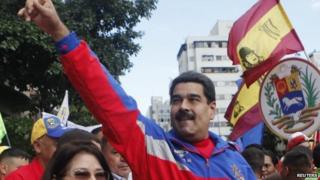 Venezuela"s President Nicolas Maduro (R) greets supporters during a rally to commemorate the 26th anniversary of the social uprising known as "Caracazo", which Venezuela"s late President Hugo Chavez said marked the start of his revolution, in this Caracas