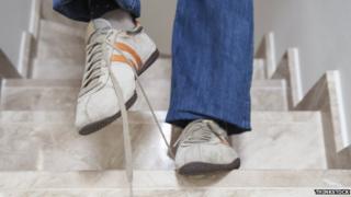 Man tripping on shoelaces