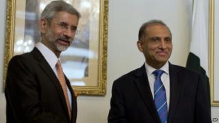 Indian Foreign Secretary Subrahmanyan Jaishankar, left, poses for photographers, as he shakes hands with his Pakistani counterpart Aizaz Chaudhry at the foreign ministry in Islamabad, Pakistan, Tuesday, March 3, 2015